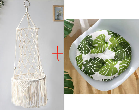 Macrame hammock chair and leaf-patterned cushion on a white surface.