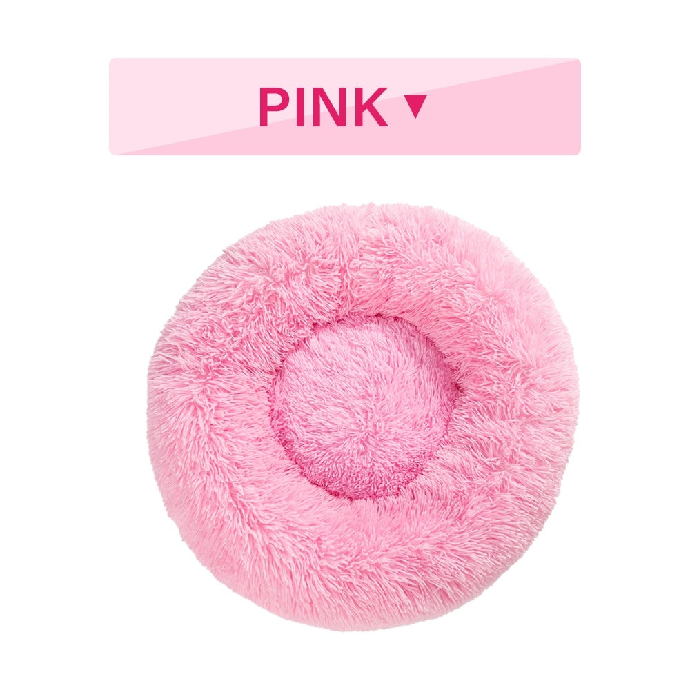 Pink fluffy pet bed with 'PINK' label on a white background