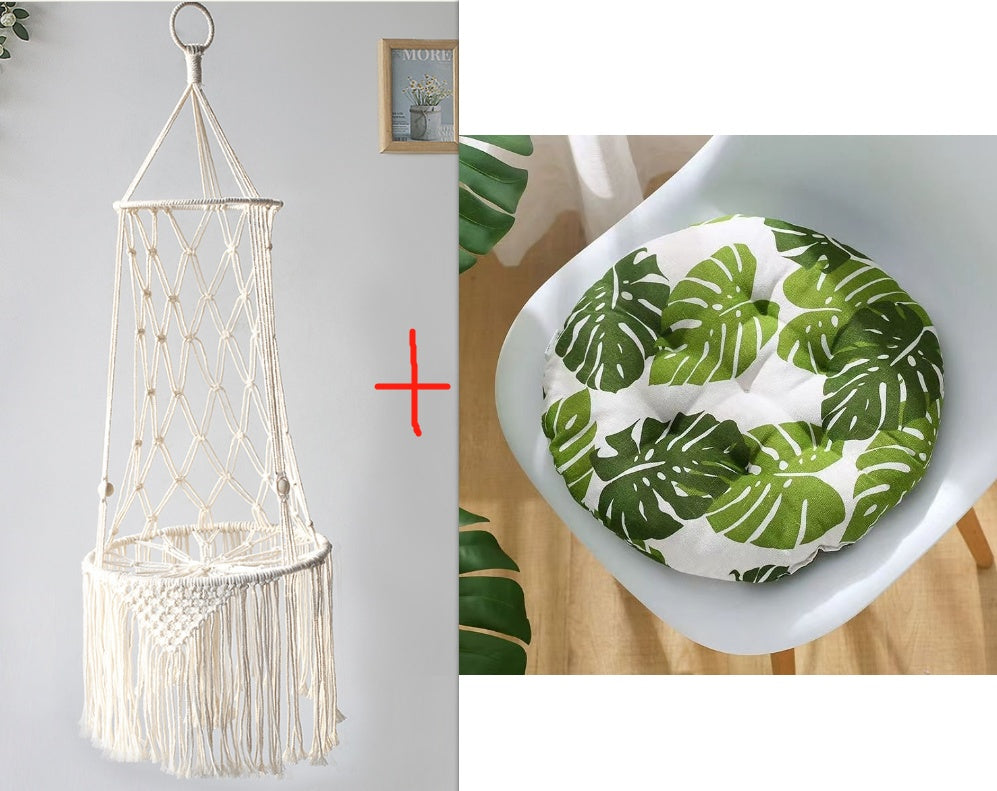 Macrame hammock chair and leaf-patterned cushion on a white surface.