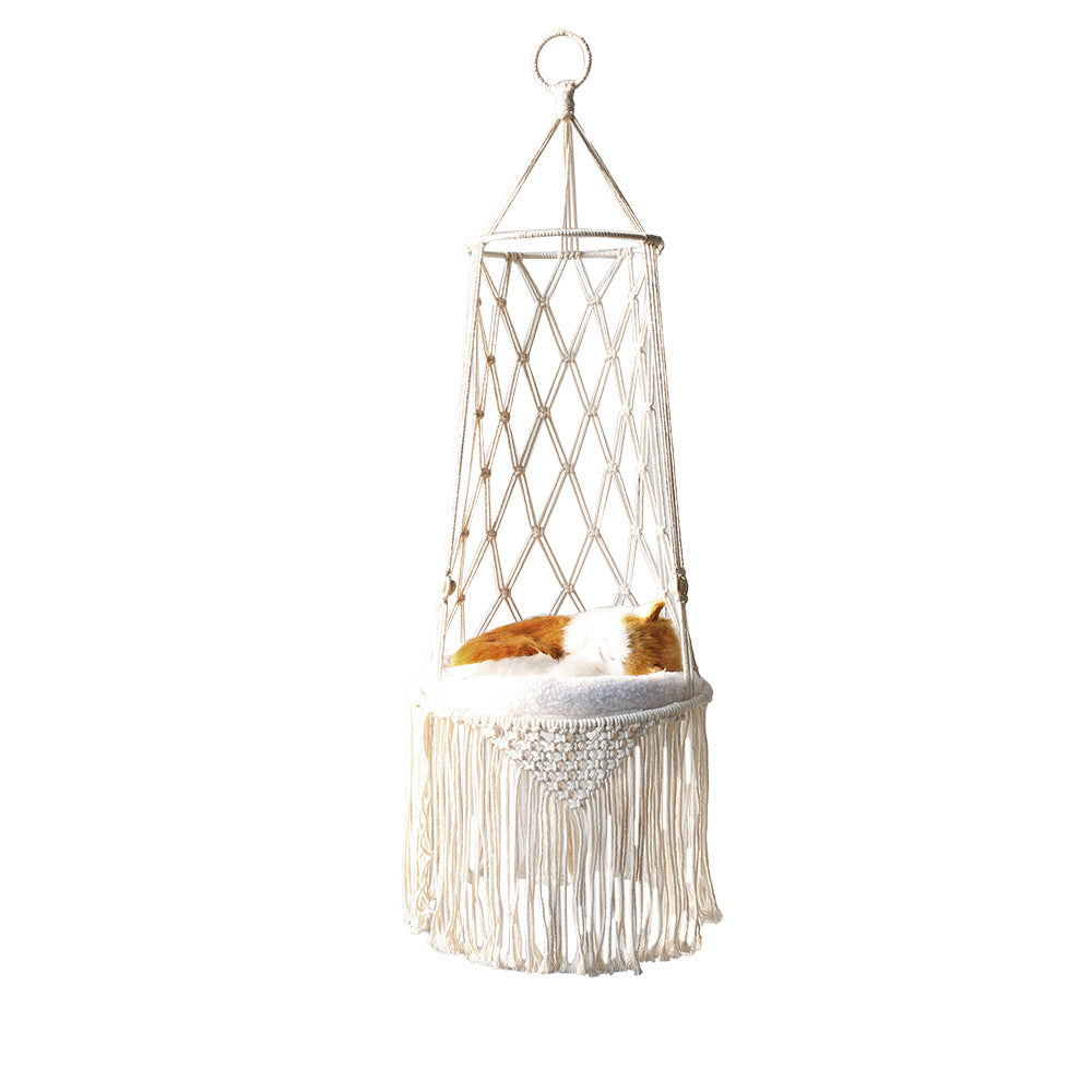 Hanging macrame chair with a cat inside on a white background